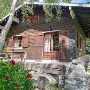a log cabin with a bench in front of it at Petit chalet l Authentique Annecy in Dingy-Saint-Clair