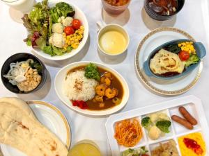 a table topped with bowls of different types of food at APA Hotel TKP Nippori Ekimae in Tokyo