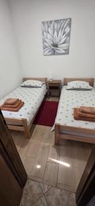 two beds sitting next to each other in a room at VILA LASOVIC + POOL + JACUZZI + SAUNA in Tuhelj
