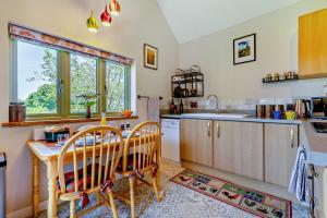 a kitchen with a table and two chairs and a table and a sink at 1 Bed in Trimingham oc-h29803 in Trimingham