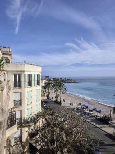 a view of a building and the beach at Victoria Plaza in Menton