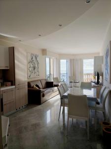 a living room with a table and a couch at Victoria Plaza in Menton