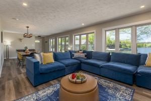 a living room with a blue couch and a table at Lakefront Suite Dock, No-Wake Cove & Firepit in Marion