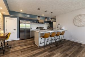 a kitchen with a counter and bar stools at Lakefront Suite Dock, No-Wake Cove & Firepit in Marion