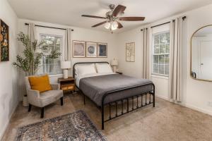 a bedroom with a bed and a fan and a chair at Walkable 2BR Cottage in Downtown Marion in Marion