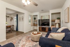 a living room with a blue couch and a tv at Walkable 2BR Cottage in Downtown Marion in Marion