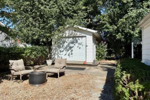 a backyard with two chairs and a garage at Walkable 2BR Cottage in Downtown Marion in Marion