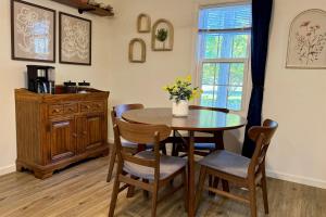 a dining room with a table and chairs and a window at Walkable 2BR Cottage in Downtown Marion in Marion +29 photos