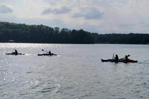 a group of people in kayaks on a lake at Classic Lakeside Vacation Sleeps 9 in Marion