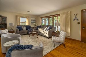 a living room with couches and chairs at Classic Lakeside Vacation Sleeps 9 in Marion