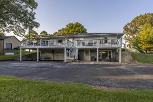 a large house with a balcony and a driveway at Classic Lakeside Vacation Sleeps 9 in Marion