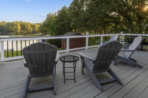 two chairs and a table on a deck at Classic Lakeside Vacation Sleeps 9 in Marion +38 photos