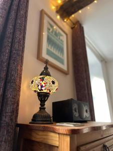 a lamp sitting on a table in a room at Carmel Cottage - Forest of Dean in Lydbrook