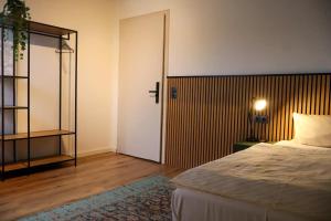 a bedroom with a bed and a door to a room at Airport Hotel Jägerhof Weeze in Weeze