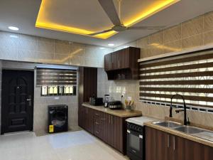 a large kitchen with a sink and a stove at Grand View Lodge in Trofwi