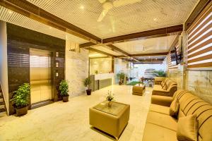 a large living room with couches and a table at Hotel Airline Inn - Near Kempegowda International Airport in Muthugadahalli