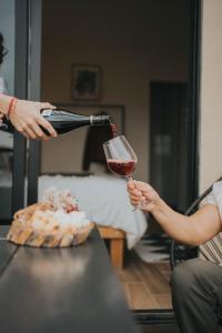 a person pouring a glass of wine on a table at Casas VV in Valle de Guadalupe