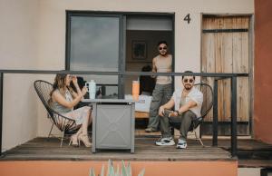 a group of people sitting in chairs on a balcony at Casas VV in Valle de Guadalupe