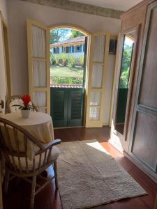 a room with a table and a chair and a window at Hotel fazenda do Cedro in Areal