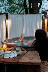 a woman laying in a pool with a drink at Chata Szyszka in Męcina Mała