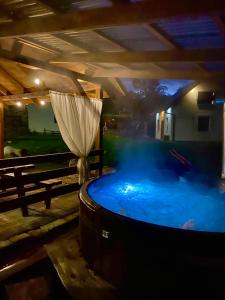 a large hot tub with an umbrella in a room at Rodzinna Przystań in Lubawka