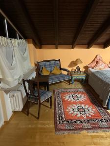 a bedroom with a bed and a chair and a table at Gästeresidenz - Hotel - Ruthellen's Home in Planegg +16 photos