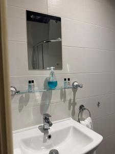 a white bathroom with a sink and a mirror at Crown & Anchor Inn in Brough +17 photos