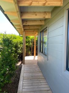 a wooden walkway leading to the front door of a house at SeaGarden Cottage in Cape St Francis
