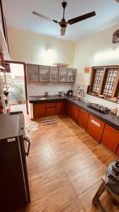 a large kitchen with wooden floors and a ceiling at Arackal in Trivandrum