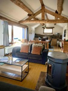 a living room with a blue couch and a table at Gîte de la chapelle in Houffalize