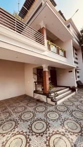 a balcony of a house with a tiled floor at Arackal in Trivandrum