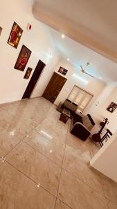 an empty living room with a large tile floor at Arackal in Trivandrum