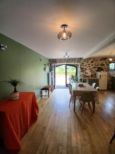 a living room with a table and a dining room at L étable au naturel in Mauriac