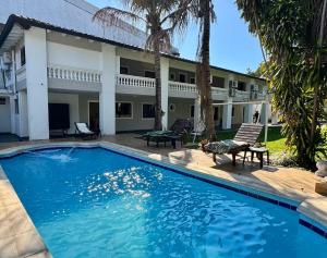 a swimming pool in front of a house at Luxurious Quinta House in Fernando de la Mora