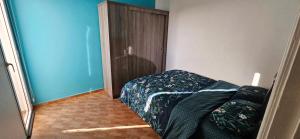 a bedroom with a bed and a wooden door at Appartement stylia 2 in Agadir +3 photos