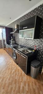 a kitchen with a sink and a stove at Appartement stylia 2 in Agadir