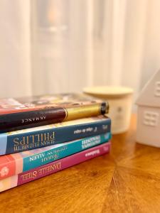 a stack of books sitting on a table at ADA Residence Lupeni acces rapid catre Straja Ski Resort in Lupeni