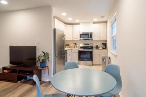 a kitchen with a table and blue chairs in a kitchen at Bright, Spacious Home with Private Deck in Potomac