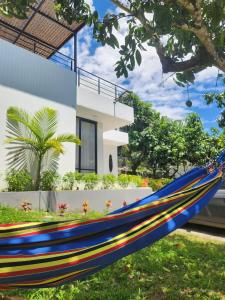 a blue hammock in front of a house at El Ensueño - Rest House in La Mesa