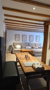 a living room with a table and a couch at Hof Busen Malibu in Mönchengladbach