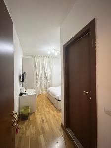 a room with a bedroom with a bed and a door at Affittacamere Seveso in Milan
