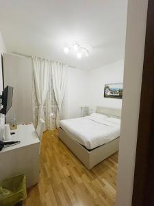 a bedroom with a bed and a desk with a computer at Affittacamere Seveso in Milan