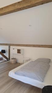 a white bedroom with a bed and a table at Hof Busen Malibu in Mönchengladbach