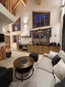 a living room with a couch and a table at Chalet am Bachl 1 in Flattach +38 photos