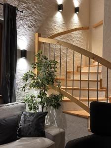 a living room with a staircase and a couch at Chalet am Bachl 1 in Flattach