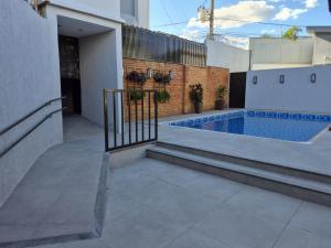 a swimming pool on the side of a building at Real Hotel in Sete Lagoas