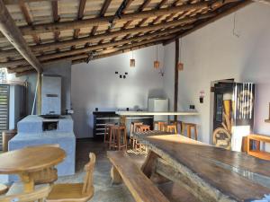 a kitchen with wooden tables and chairs in a room at Real Hotel in Sete Lagoas