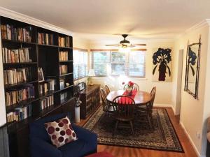 a dining room with a table and bookshelves at Cozy Bedroom Convenient Location in Bethesda