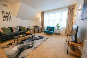 a living room with a couch and a television at StayPoint in Eastbourne