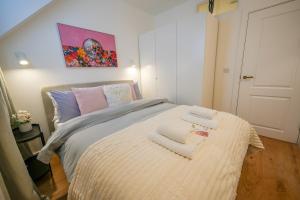 a bedroom with a bed with two towels on it at StayPoint in Eastbourne